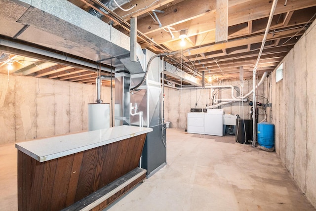 4104 Rurik Dr, Howell, MI 48843 - unfinished basement with separate washer and dryer, water heater, heating unit, and a water pressure tank