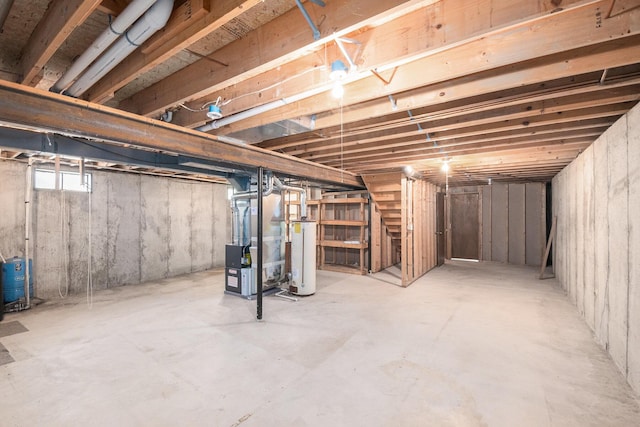 4104 Rurik Dr, Howell, MI 48843 - below grade area featuring heating unit, gas water heater, a water pressure tank, and stairway