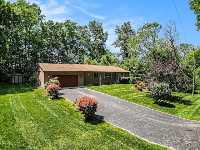 4104 Rurik Dr, Howell, MI 48843 - single story home featuring driveway, a garage, a front yard, a chimney, and a storage shed