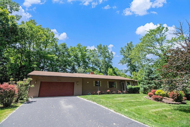 4104 Rurik Dr, Howell, MI 48843 - ranch-style house featuring a garage, a front yard, driveway, and a chimney