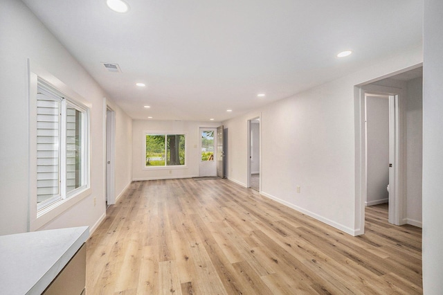 1694 S Mill Iron Rd, Muskegon, MI 49442 - unfurnished living room featuring recessed lighting and light wood-type flooring