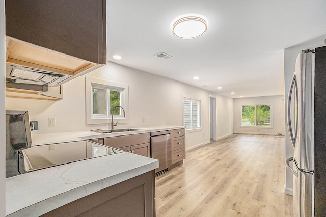 1694 S Mill Iron Rd, Muskegon, MI 49442 - kitchen with stainless steel appliances, light countertops, light wood finished floors, and recessed lighting