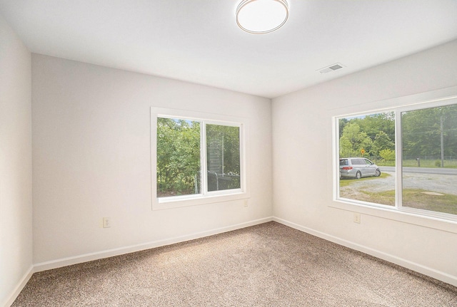 1694 S Mill Iron Rd, Muskegon, MI 49442 - carpeted empty room with healthy amount of natural light