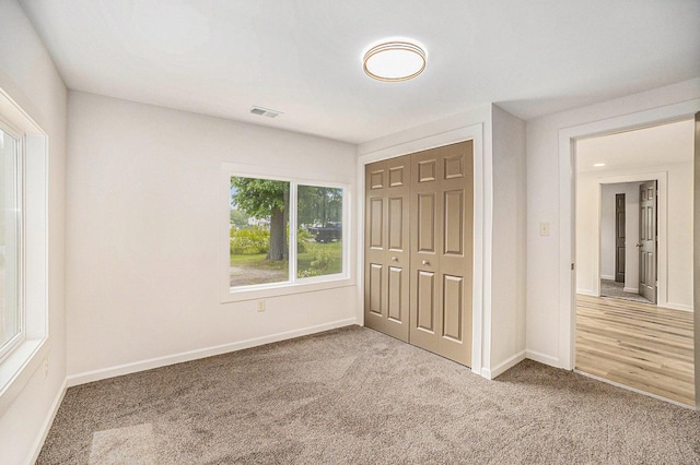 1694 S Mill Iron Rd, Muskegon, MI 49442 - unfurnished bedroom featuring carpet flooring and a closet