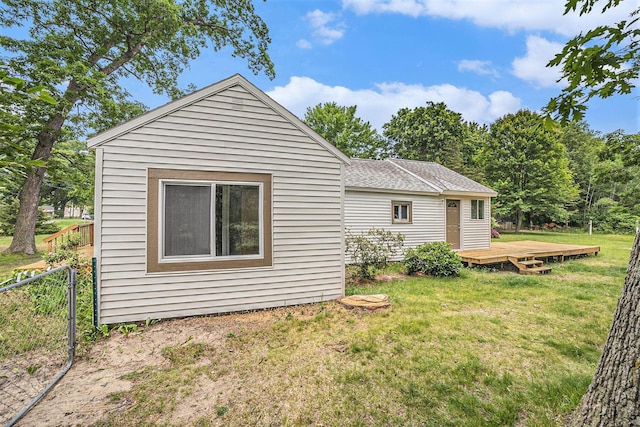 1694 S Mill Iron Rd, Muskegon, MI 49442 - view of side of home featuring a wooden deck and a shingled roof