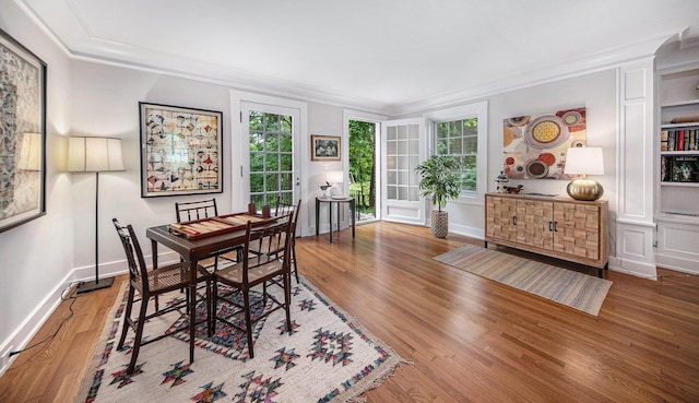 809 Berkshire Rd, Ann Arbor, MI 48104 - dining area with crown molding, healthy amount of natural light, and wood finished floors