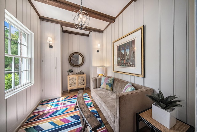 809 Berkshire Rd, Ann Arbor, MI 48104 - living room with a chandelier, beam ceiling, a decorative wall, and wood finished floors