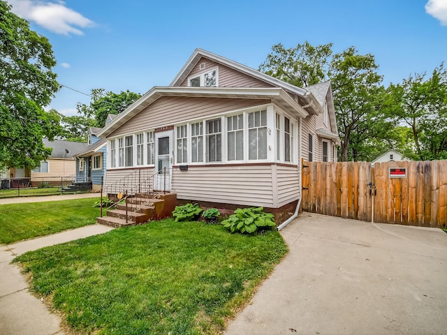 769 Evanston Ave, Muskegon, MI 49442 - bungalow featuring a gate and a sunroom