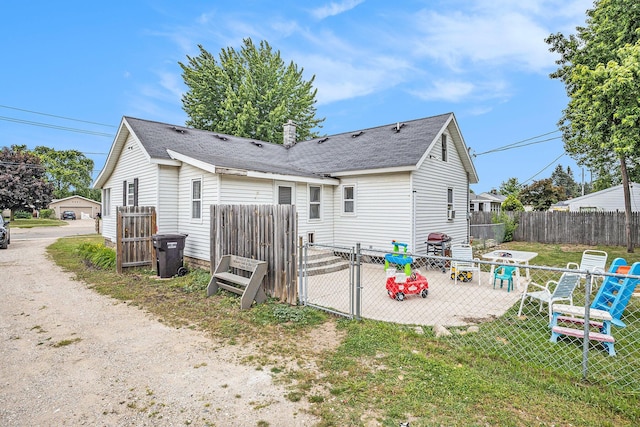 6710 28th Ave, Hudsonville, MI 49426 - back of house featuring a gate, roof with shingles, and a patio