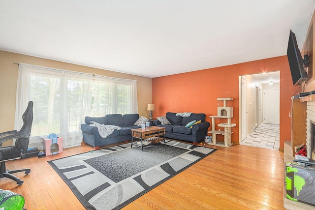 11738 Apple Dr, Nunica, MI 49448 - living area with hardwood / wood-style flooring and a brick fireplace