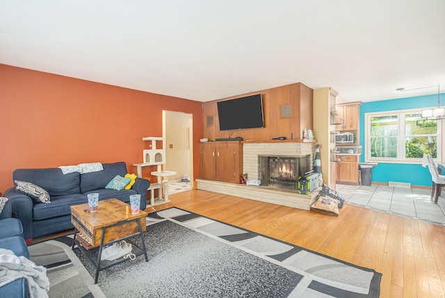 11738 Apple Dr, Nunica, MI 49448 - living area with light wood finished floors and a fireplace