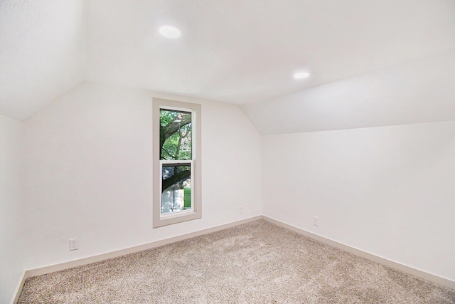 410 Warren Ave, Charlotte, MI 48813 - additional living space with vaulted ceiling, carpet flooring, and recessed lighting