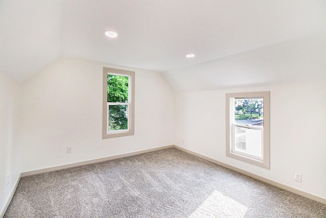 410 Warren Ave, Charlotte, MI 48813 - additional living space with vaulted ceiling, carpet floors, and recessed lighting