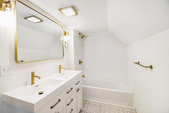 410 Warren Ave, Charlotte, MI 48813 - full bath with lofted ceiling, double vanity, bathing tub / shower combination, and tile patterned floors