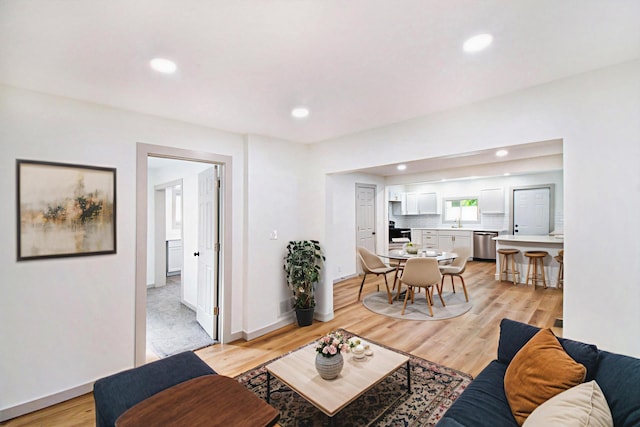 410 Warren Ave, Charlotte, MI 48813 - living area with recessed lighting and light wood-style floors
