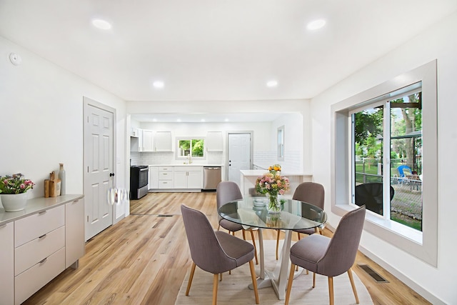 410 Warren Ave, Charlotte, MI 48813 - dining space with light wood-style flooring and recessed lighting