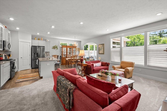 4441 Koinonia Dr NE Unit 3, Grand Rapids, MI 49525 - living area with recessed lighting, light carpet, a textured ceiling, and arched walkways