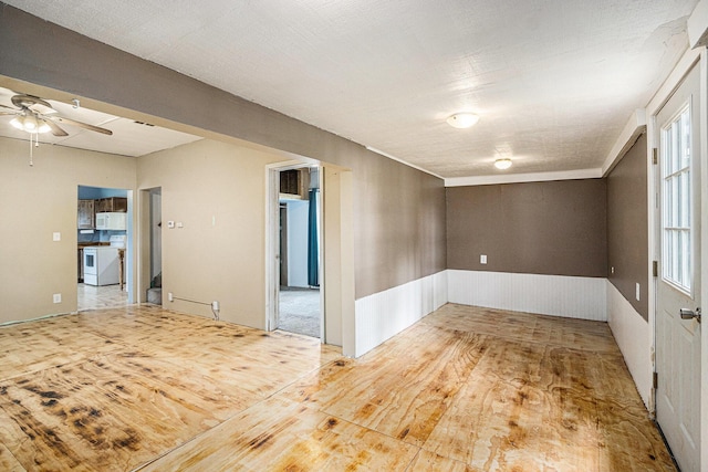 2943 108th Ave, Allegan, MI 49010 - unfurnished room featuring a ceiling fan, wood finished floors, and a wainscoted wall