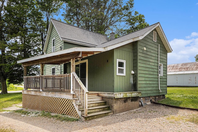2943 108th Ave, Allegan, MI 49010 - view of front of property featuring covered porch, a chimney, and roof with shingles