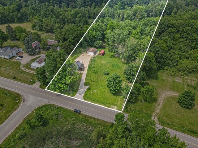 2943 108th Ave, Allegan, MI 49010 - aerial view of property and surrounding area with a heavily wooded area and property boundaries highlighted