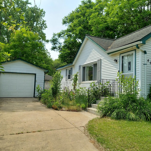 246 Ridgeway Rd, Jackson, MI 49202 - view of property exterior with an outbuilding, a garage, driveway, and a shingled roof