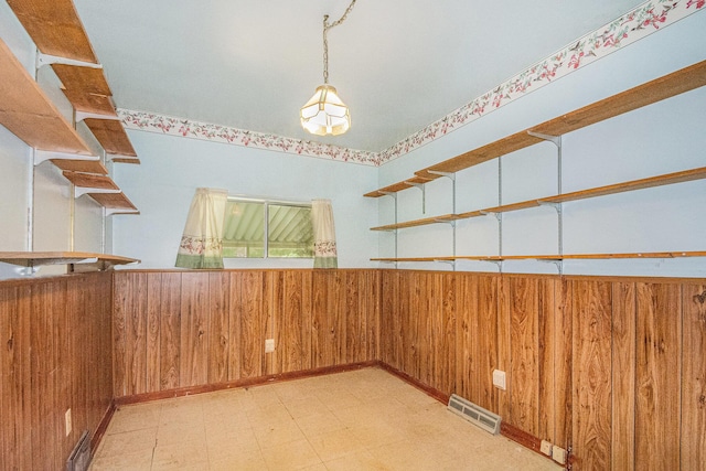 246 Ridgeway Rd, Jackson, MI 49202 - spare room with tile patterned floors and wooden walls