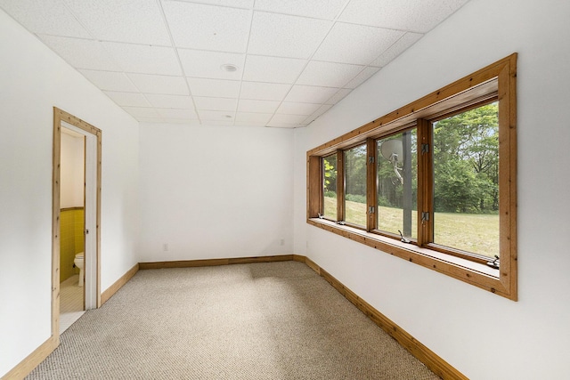 6483 N 144th Ave, Walkerville, MI 49459 - empty room featuring plenty of natural light, light colored carpet, and a paneled ceiling