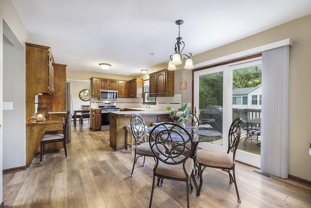 1863 Sunvale Dr SW, Wyoming, MI 49519 - dining space featuring light wood-style floors and baseboards