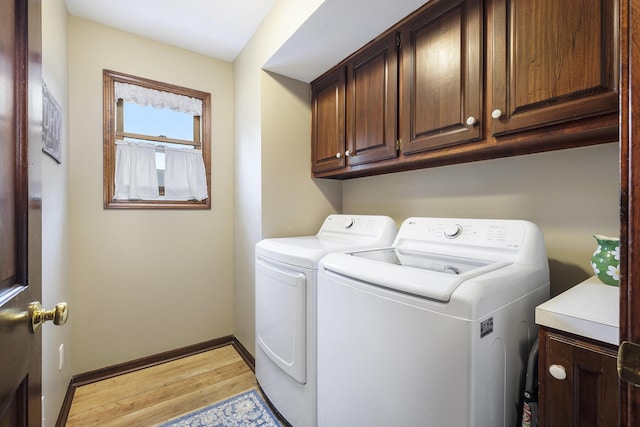 1863 Sunvale Dr SW, Wyoming, MI 49519 - washroom featuring cabinet space, light wood-style floors, and washing machine and dryer