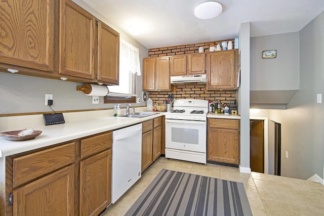 8683 Hemlock Ct, Ypsilanti, MI 48198 - kitchen with white appliances, under cabinet range hood, light tile patterned flooring, light countertops, and brown cabinetry