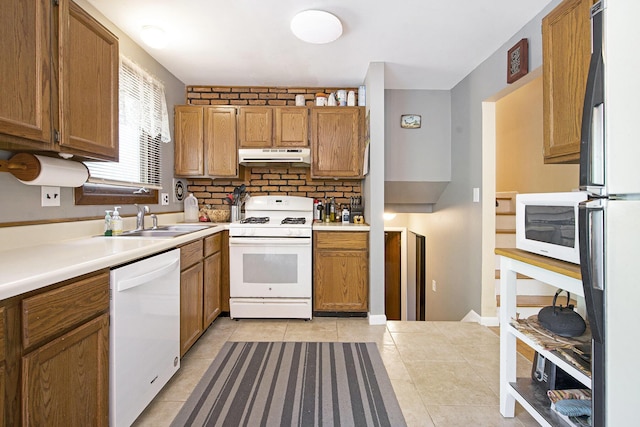 8683 Hemlock Ct, Ypsilanti, MI 48198 - kitchen with white appliances, under cabinet range hood, light tile patterned floors, light countertops, and brown cabinets