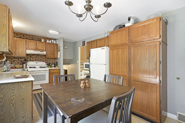 8683 Hemlock Ct, Ypsilanti, MI 48198 - dining room featuring a chandelier and baseboards