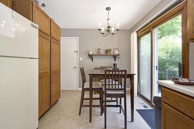 8683 Hemlock Ct, Ypsilanti, MI 48198 - dining area featuring plenty of natural light, a chandelier, and light tile patterned floors