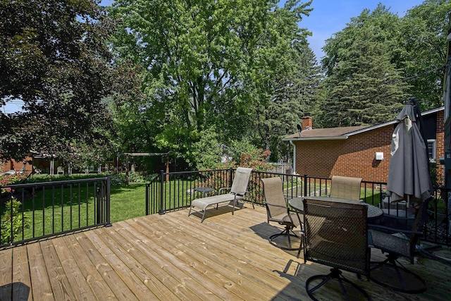 8683 Hemlock Ct, Ypsilanti, MI 48198 - wooden deck featuring a yard, outdoor dining area, and view of wooded area