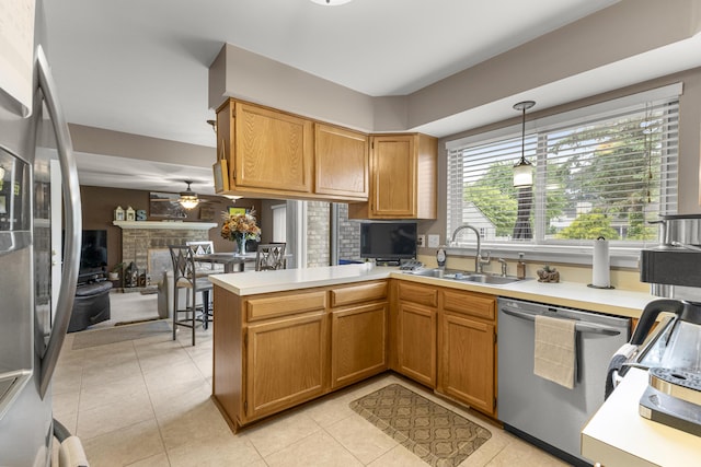 24663 Balsam Ct, Flat Rock, MI 48134 - kitchen with stainless steel appliances, a ceiling fan, a peninsula, light countertops, and light tile patterned floors