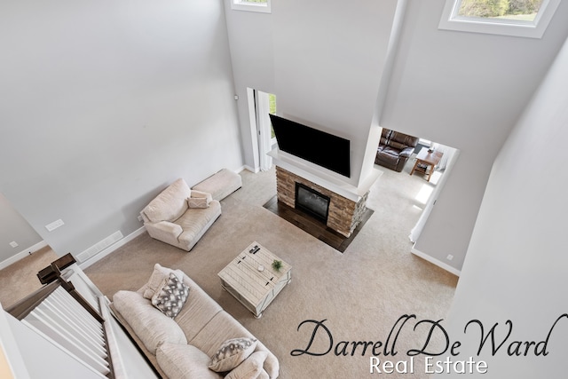 3940 Egypt Valley Ave NE, Ada, MI 49301 - carpeted living area with a high ceiling and a fireplace