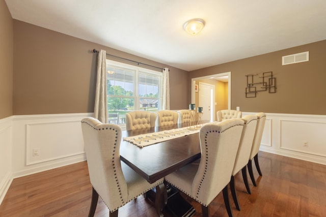 1481 Kristen Path, Saint Joseph, MI 49085 - dining room with a decorative wall, dark wood-style flooring, and a wainscoted wall