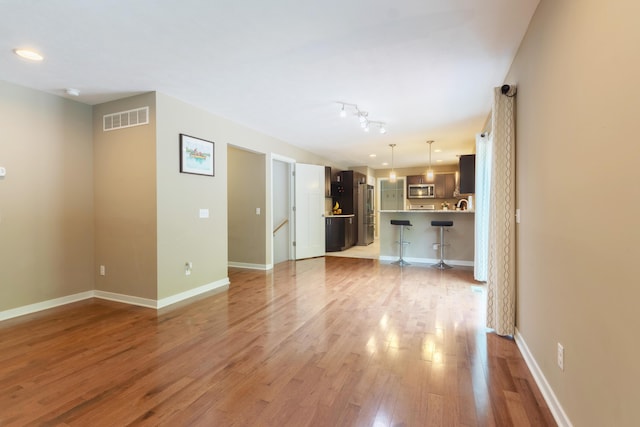 1481 Kristen Path, Saint Joseph, MI 49085 - unfurnished living room with light wood-style flooring and baseboards