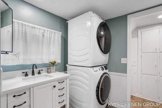 15405 Barry St, West Olive, MI 49460 - laundry room with stacked washer / drying machine, wainscoting, and wood finished floors