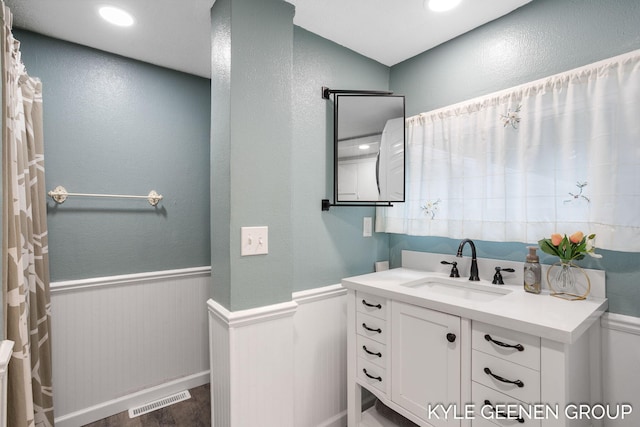 15405 Barry St, West Olive, MI 49460 - full bathroom with wainscoting, vanity, wood finished floors, and recessed lighting