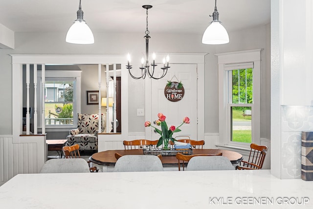 15405 Barry St, West Olive, MI 49460 - dining space with a chandelier and wainscoting