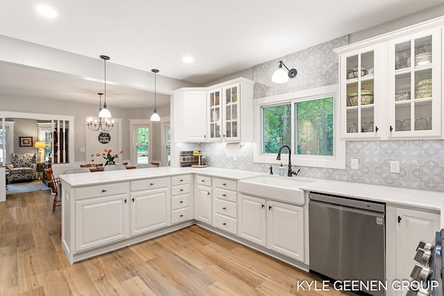 15405 Barry St, West Olive, MI 49460 - kitchen with stainless steel dishwasher, a peninsula, light countertops, and recessed lighting