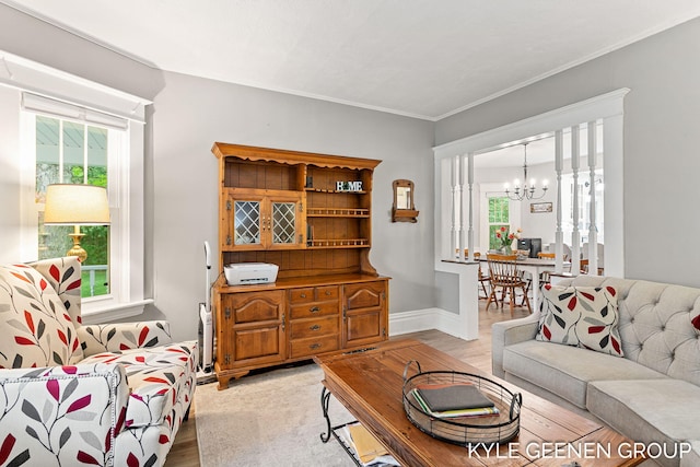 15405 Barry St, West Olive, MI 49460 - living area featuring a chandelier, light wood-style floors, and ornamental molding