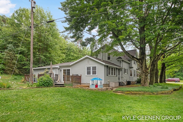 15405 Barry St, West Olive, MI 49460 - rear view of house featuring a wooden deck, a lawn, and entry steps