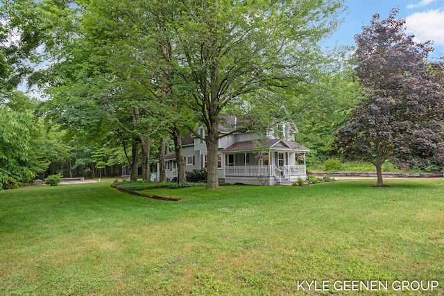 15405 Barry St, West Olive, MI 49460 - view of green lawn with a porch