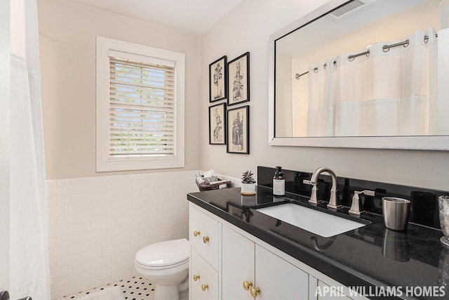 740 Van Raalte Ave, Holland, MI 49423 - bathroom with vanity, tile walls, wainscoting, tile patterned floors, and a shower with shower curtain