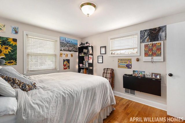 740 Van Raalte Ave, Holland, MI 49423 - bedroom featuring multiple windows and wood finished floors