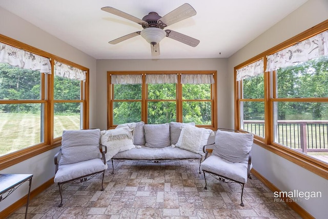 3192 W Sisson Rd, Freeport, MI 49325 - living room featuring stone finish flooring, plenty of natural light, and a ceiling fan