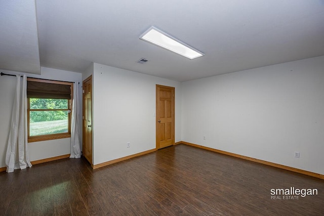 3192 W Sisson Rd, Freeport, MI 49325 - unfurnished room with baseboards and dark wood-style floors