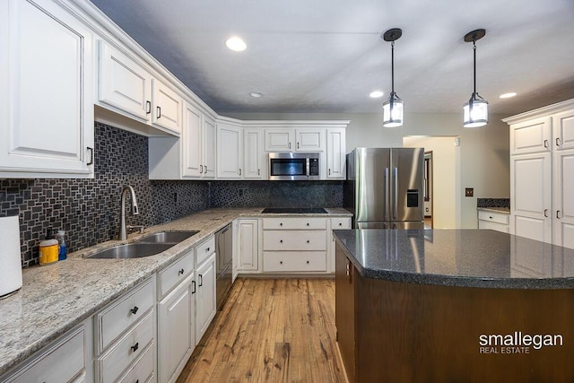 3192 W Sisson Rd, Freeport, MI 49325 - kitchen with appliances with stainless steel finishes, white cabinets, decorative backsplash, and recessed lighting